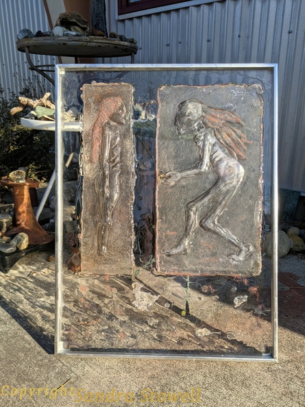 These are two individual figures cast separately from a three figure mold. These are mounted on an 18 x24 sheet of clear acrylic.
There is another photo of this piece taken flat on an opaque background. Beseeching or The Face Off outdoorphoto.jpg
