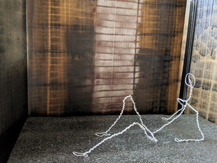 Wire armature figure lying resting on one elbow